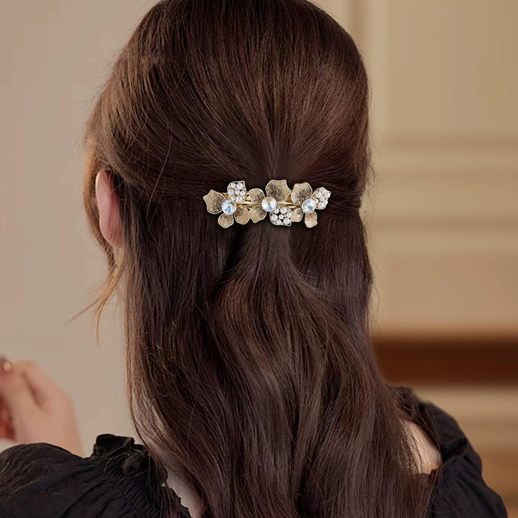 Blue-tone floral branch barrette worn in hair