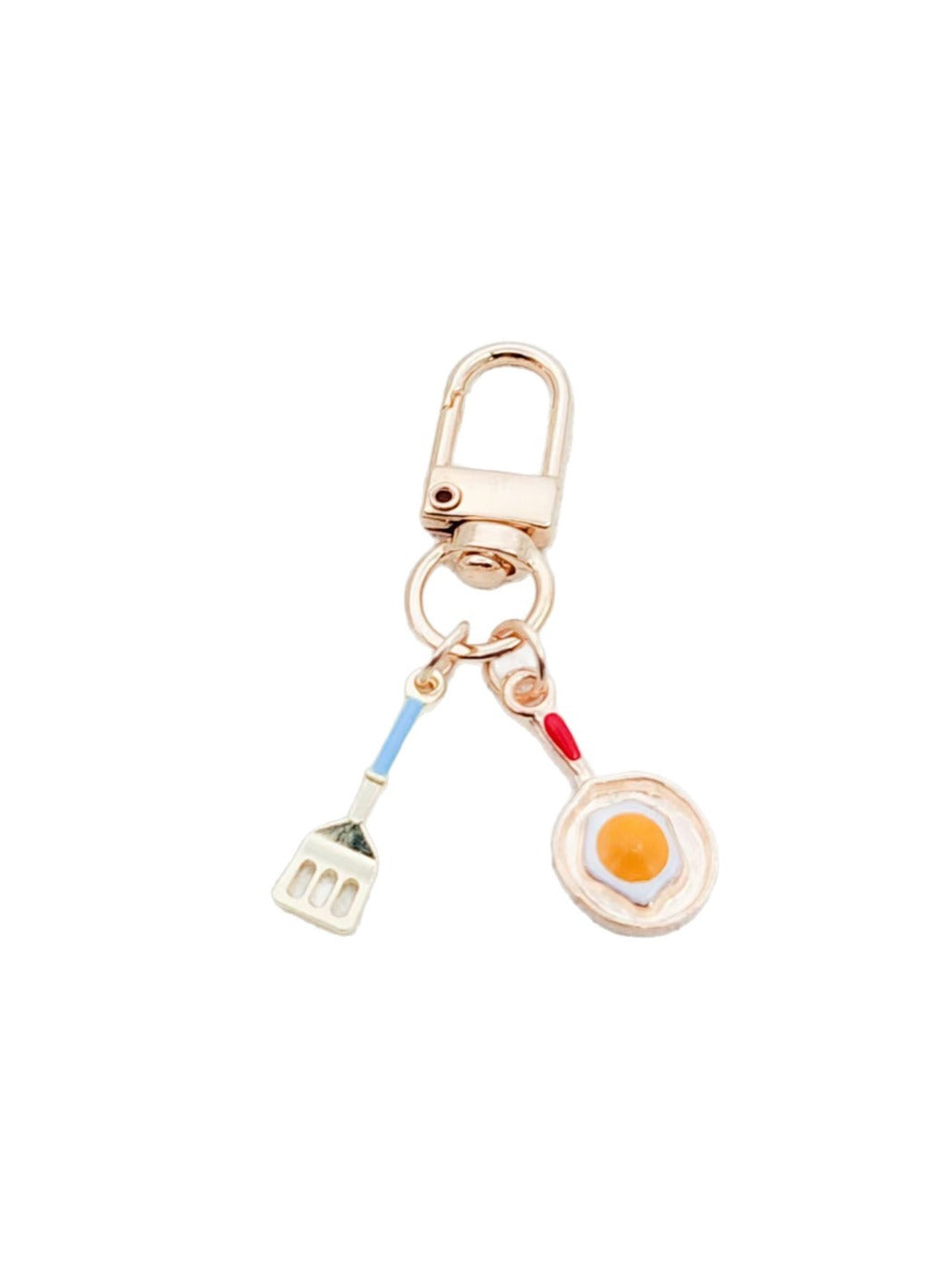 Fried egg keychain held in hand to show size and detail