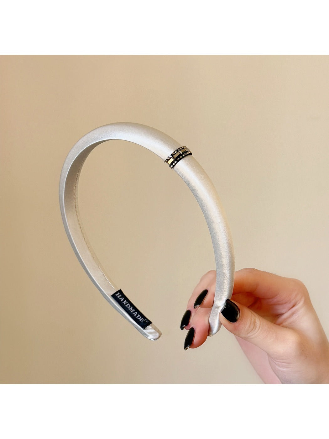 Gifty satin headband displayed on a mannequin head highlighting minimalist design
