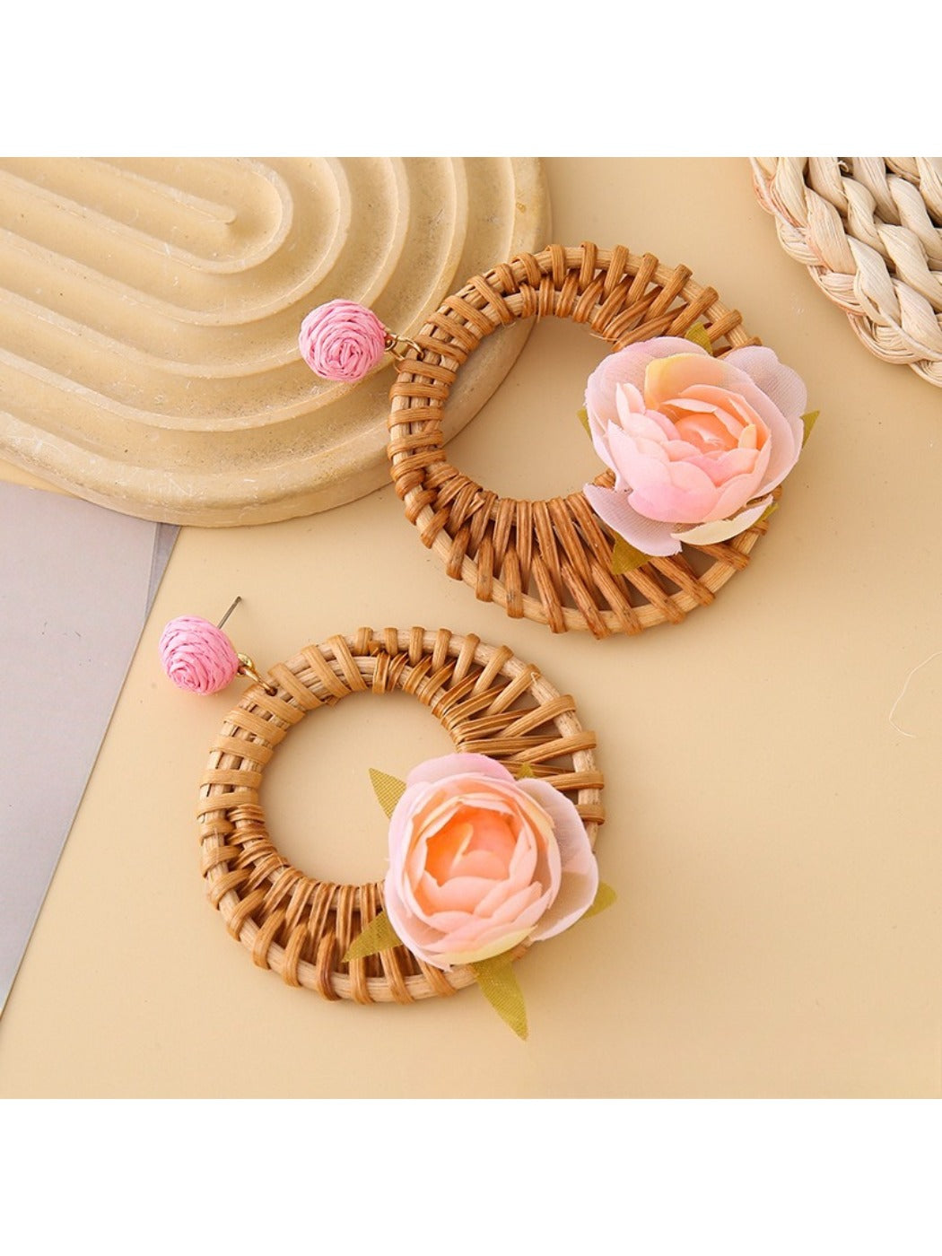Vintage rattan woven circle earrings placed on wooden surface