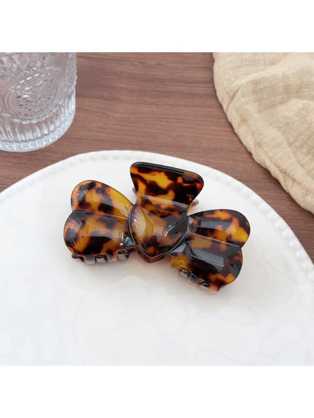 Beau bow shaped hair claw clip styled in a casual half-up hairstyle