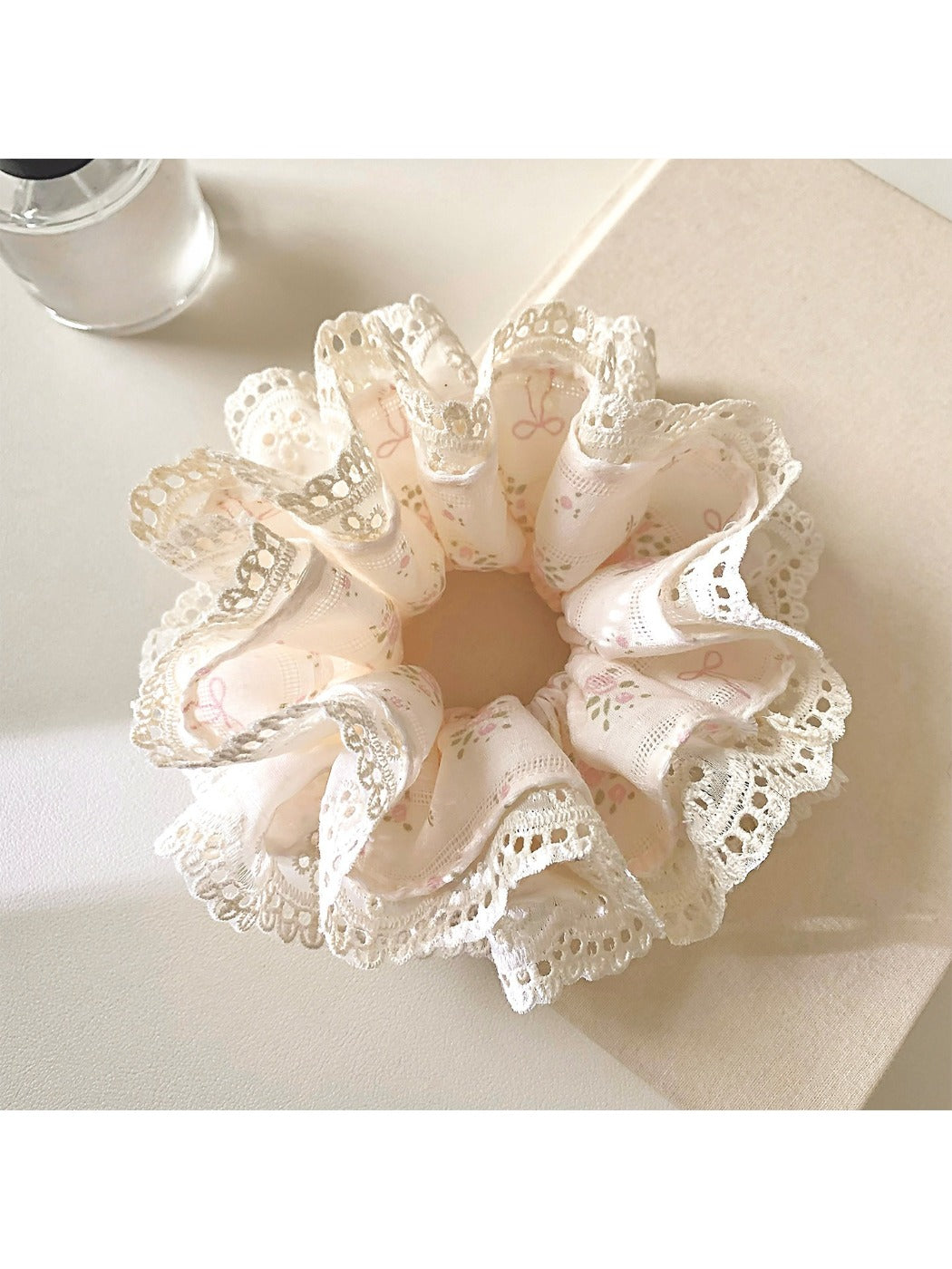 Gifty Sweet Bow Print Ruffled Scrunchie worn on a wrist showcasing its size and pattern
