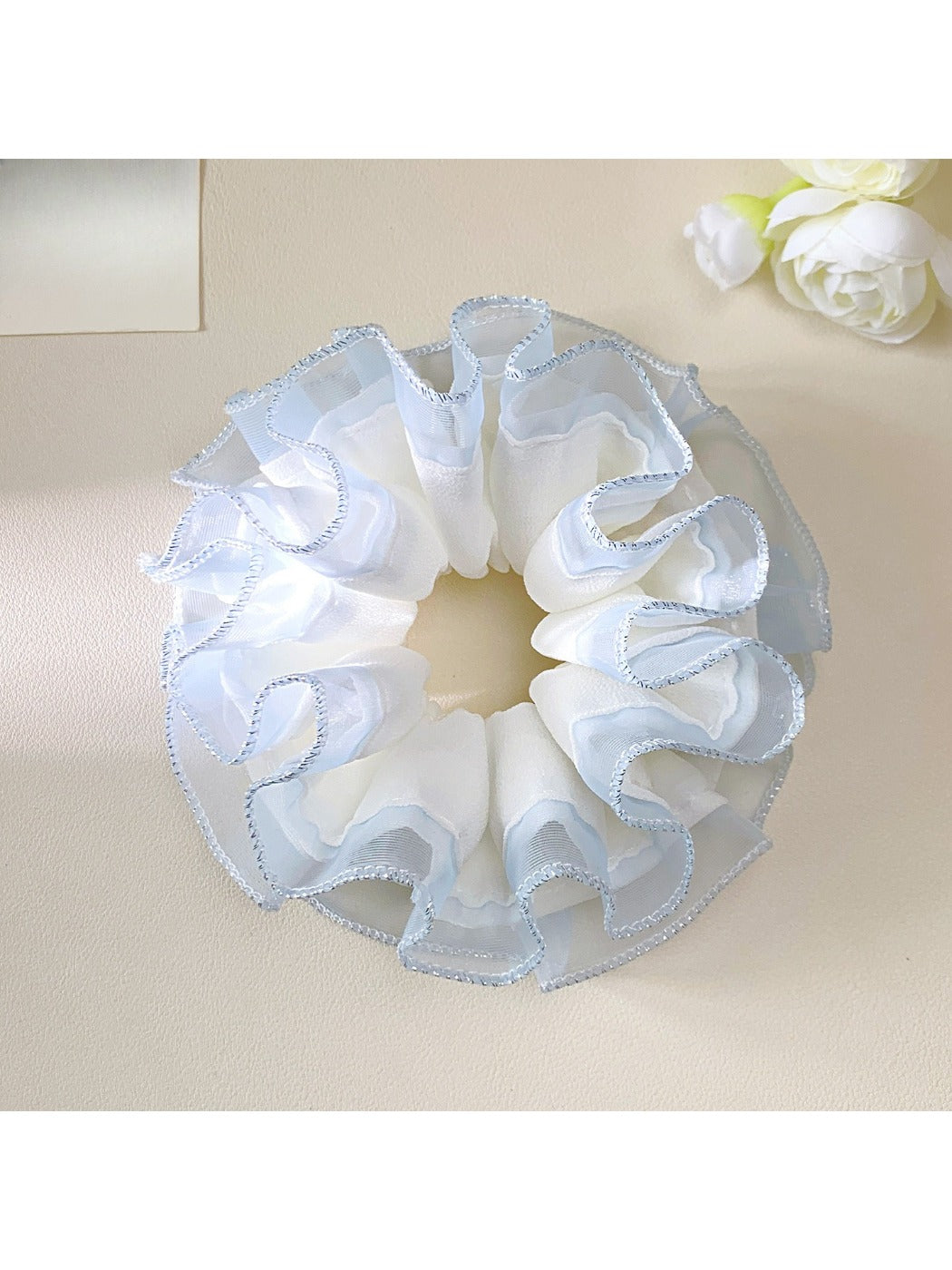 Gifty tulle ruffle scrunchie displayed on a white background highlighting its airy design