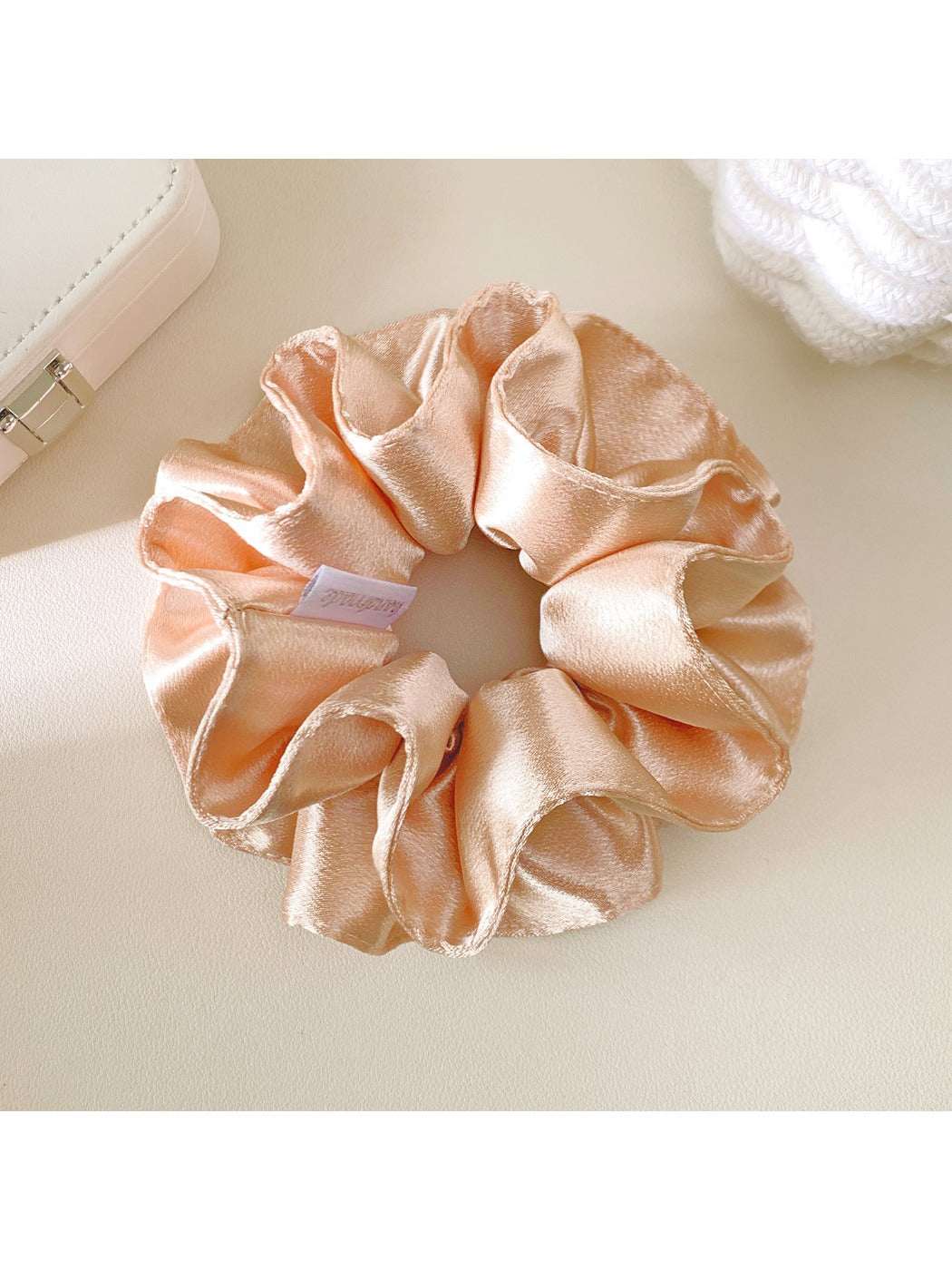 Flat lay of multiple Gifty satin double layer scrunchies in various colors arranged in a circle