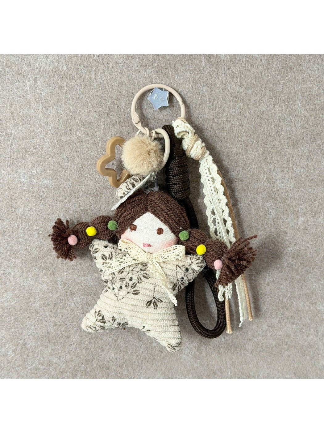 Keypus fabric cartoon doll keychain held in hand to show size and scale