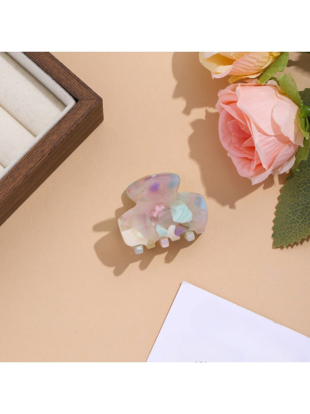 Beau vibrant acetate hair clip resting on a neutral fabric surface
