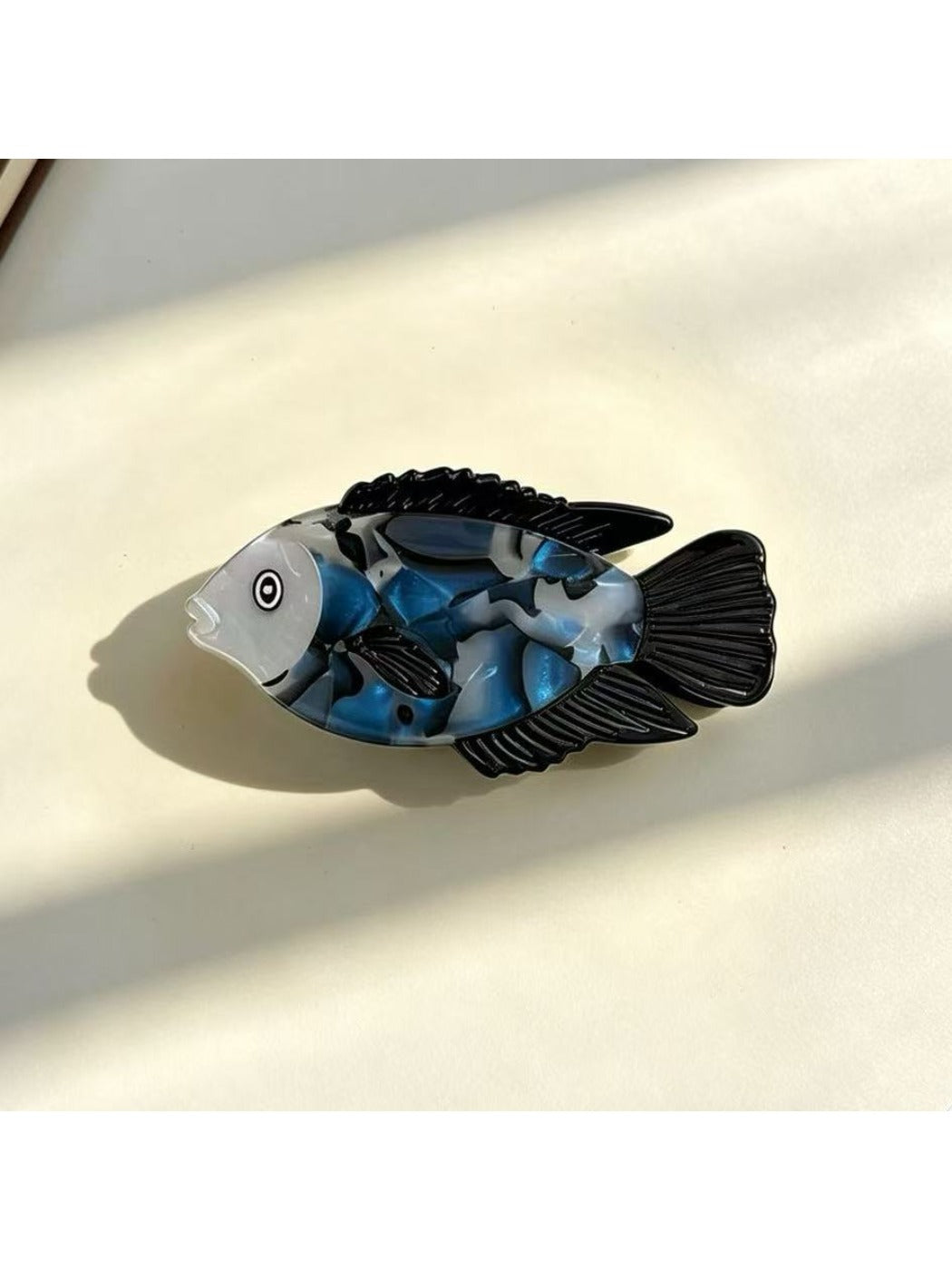 Beau fish claw clip worn in a half-up hairstyle on dark hair