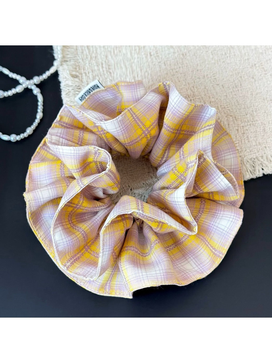 Yellow plaid scrunchie paired with casual outfit on model