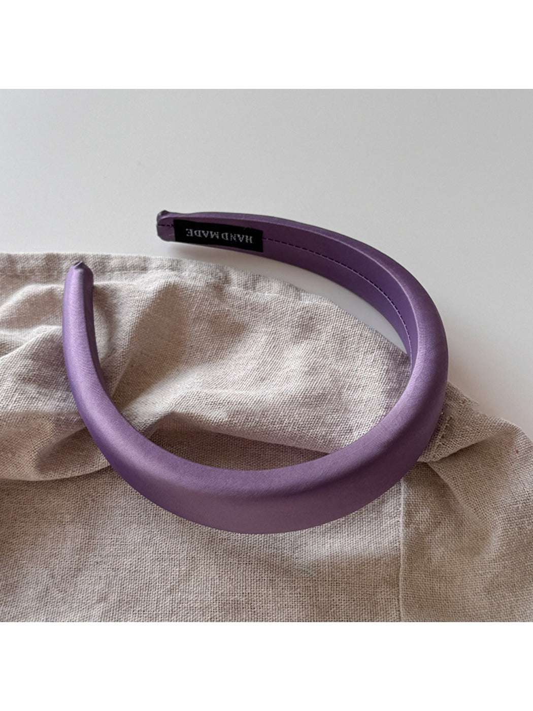 Purple wide edge headband displayed alongside other color options