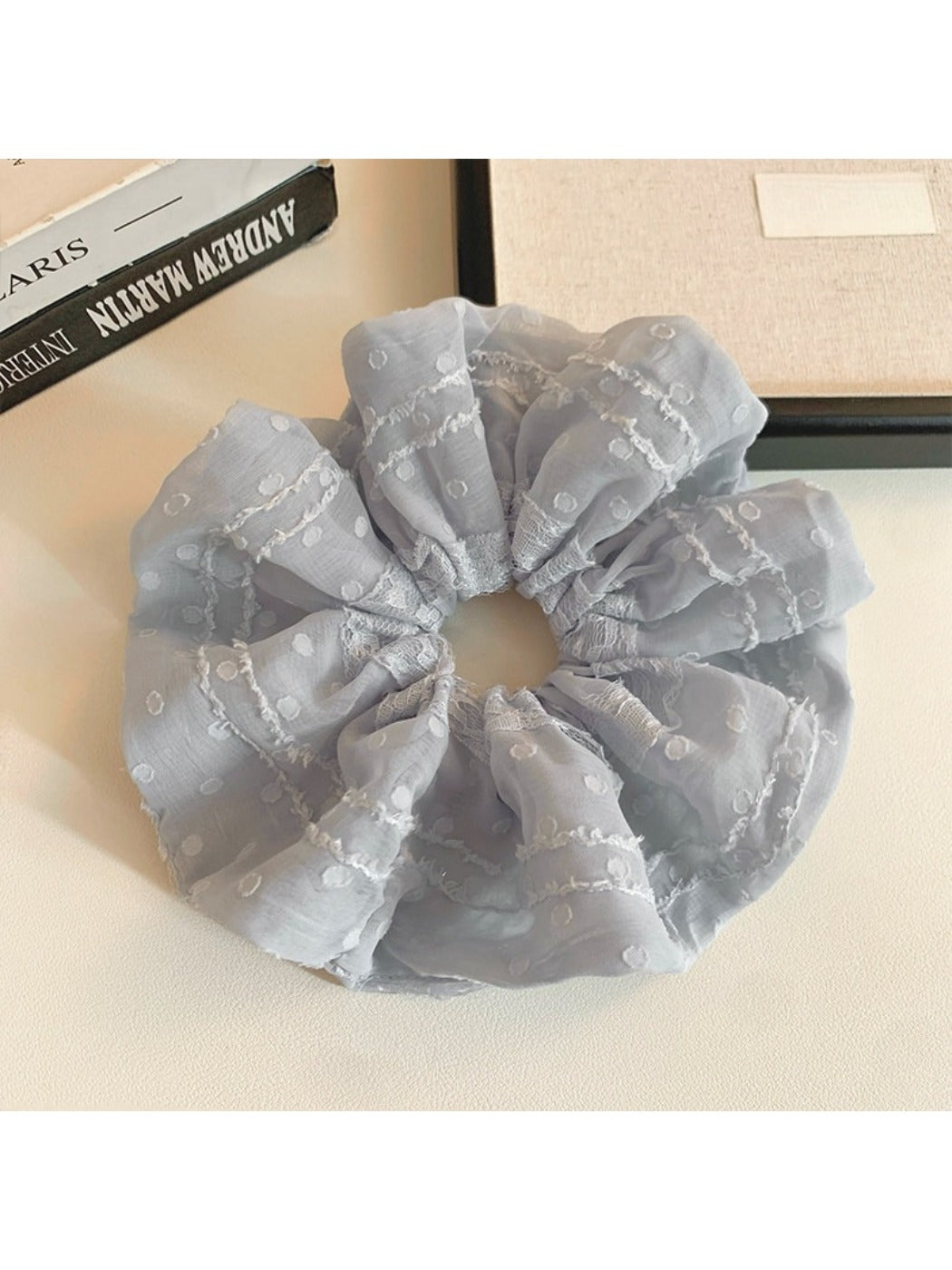 Gifty scrunchie wrapped around a ponytail, highlighting its ruffled design