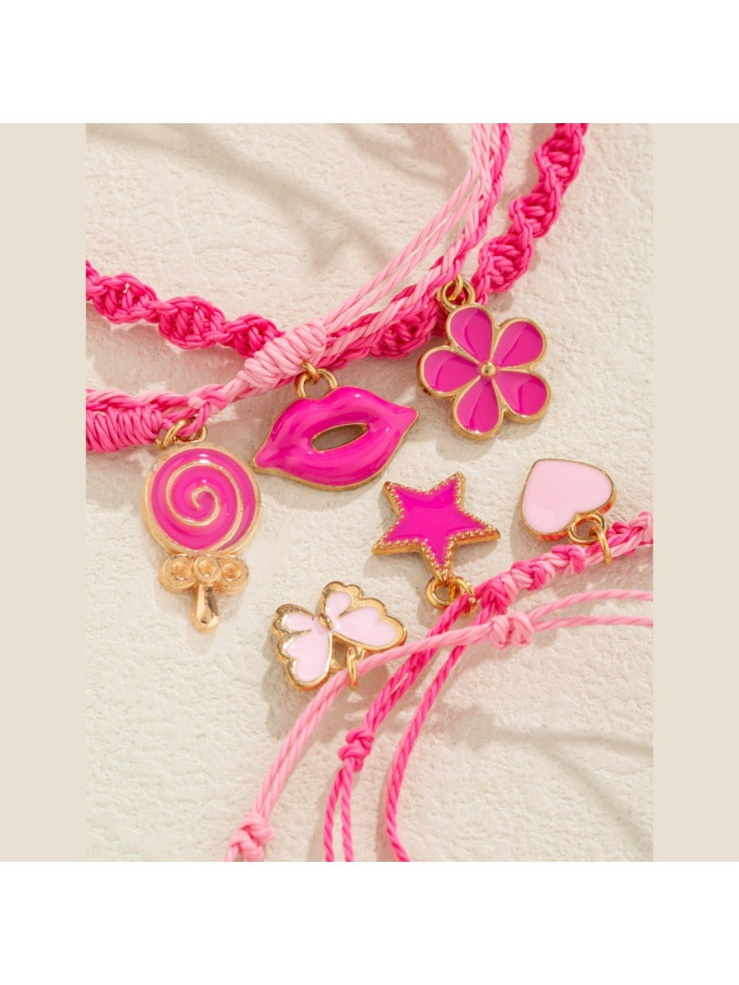 Close-up of Lovra pink pendant layered bracelet showing detailed pink pendant and chain links