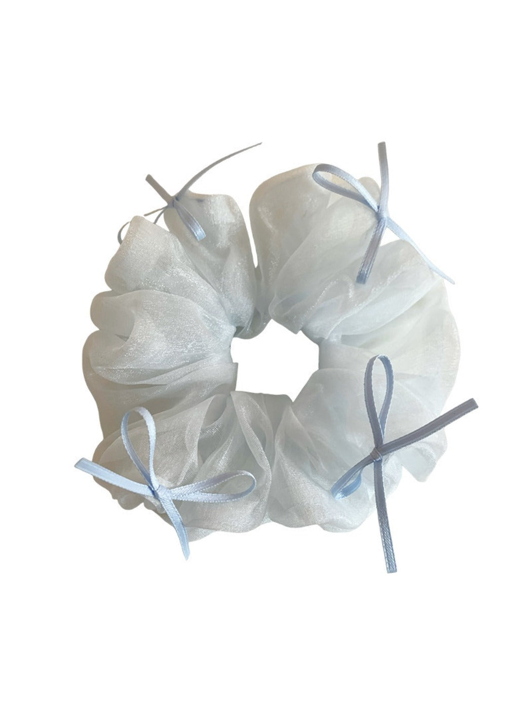 Blue tulle ribbon bow scrunchie laid flat highlighting bow shape and fabric