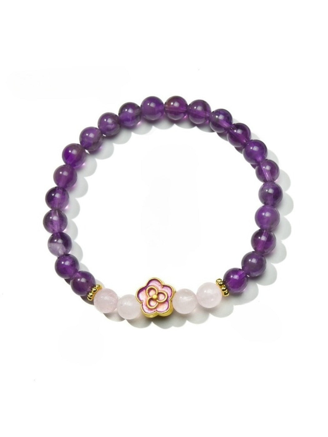 Lovra vintage floral beaded bracelet styled with other jewelry on a wooden surface