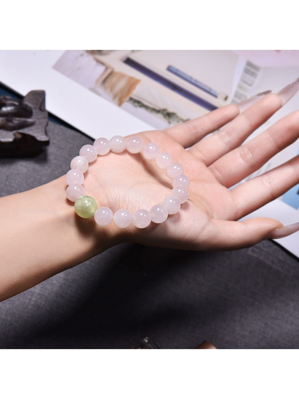 Model wearing Lovra minimalist pink crystal beaded bracelet on wrist with casual outfit