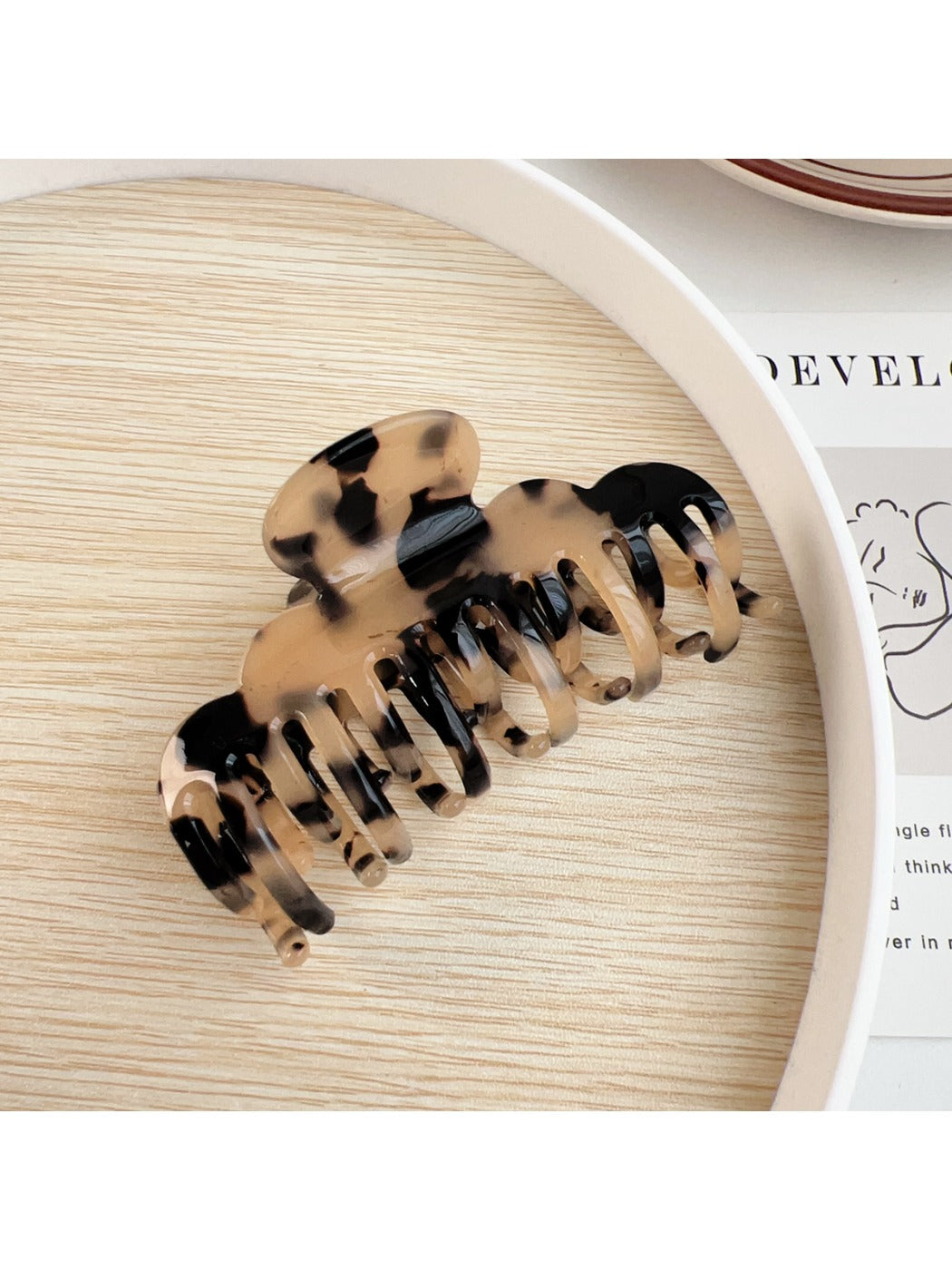 Beau double row crescent shaped claw clip packaged in branded box