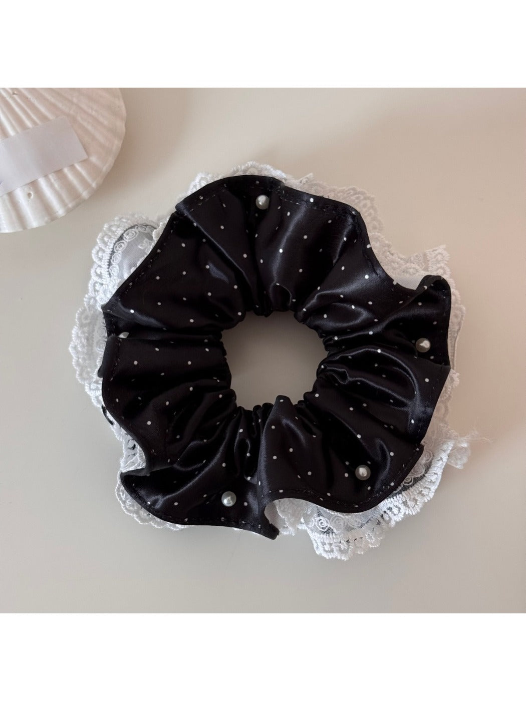 Gifty polka dot scrunchie styled in a ponytail with soft fabric folds visible