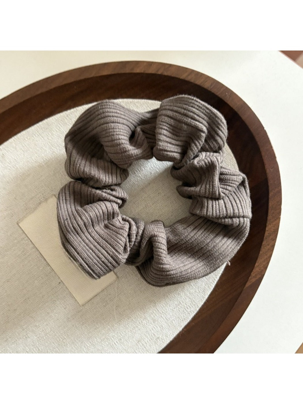 Gifty scrunchie in natural light emphasizing neutral color stripes