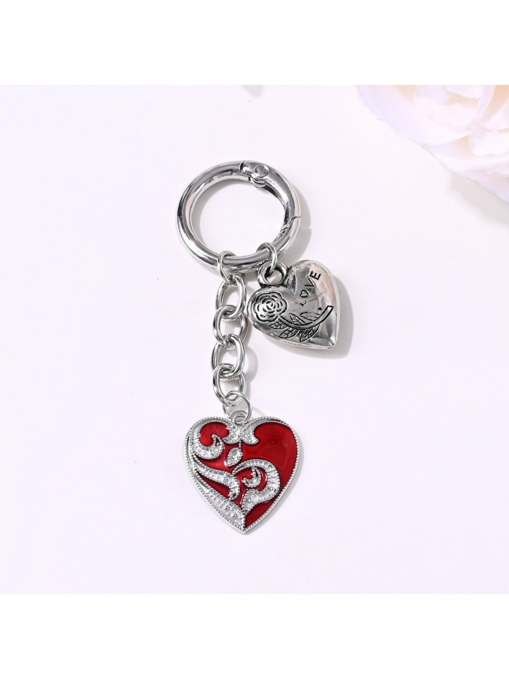 Close-up of the bow detail on the alloy heart keychain with reflective surface