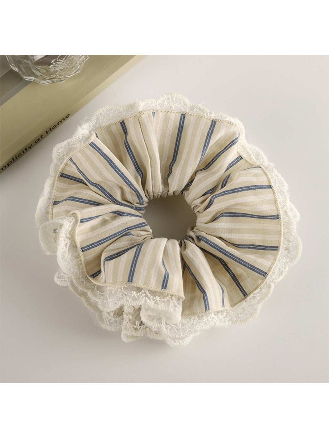 Gifty scrunchie with black and white stripes in a loose circular shape