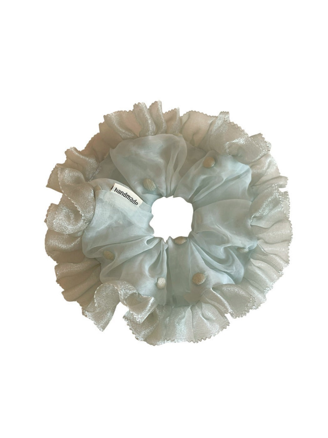 Side view of Gifty tulle ruffle scrunchie highlighting layered fabric and elastic band