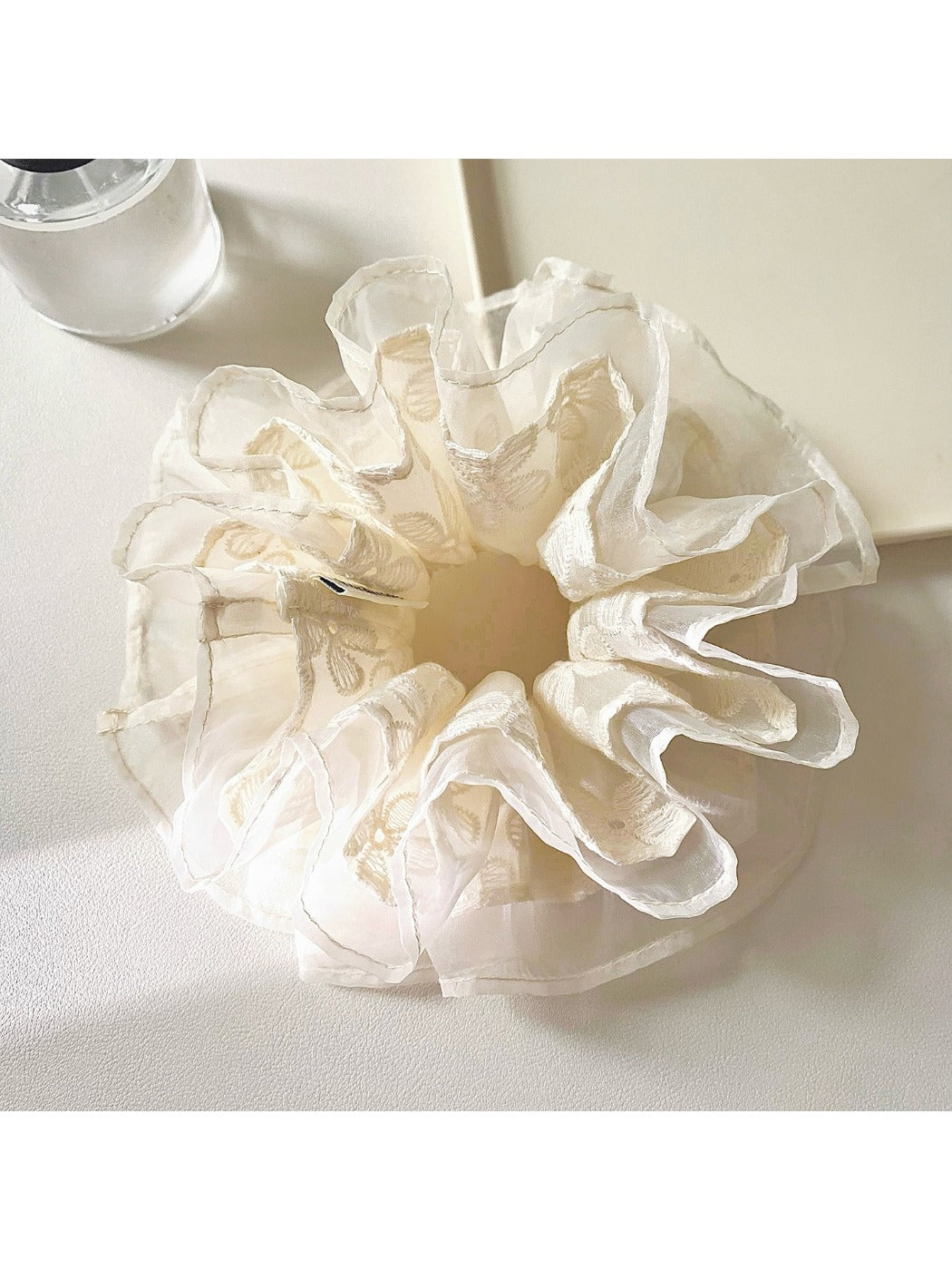 Side view of Gifty embroidered flower scrunchie showing delicate tulle fabric