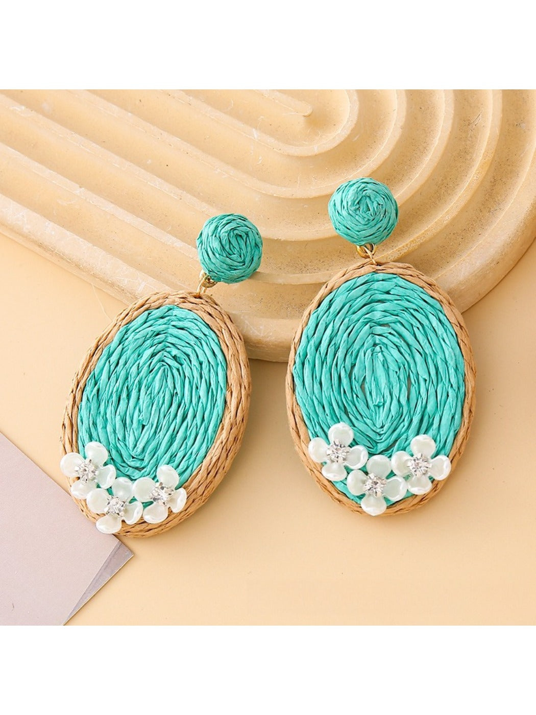 Detailed shot of the woven raffia pattern on Earedge oval shape earrings