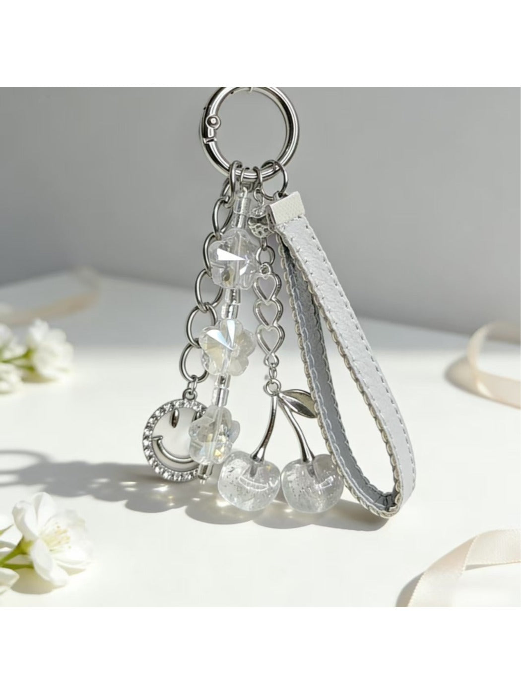 Keypus cherry charm keychain held in hand showing size and detail