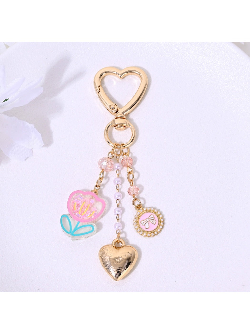 Red leather heart flower bag charm keychain displayed on white background