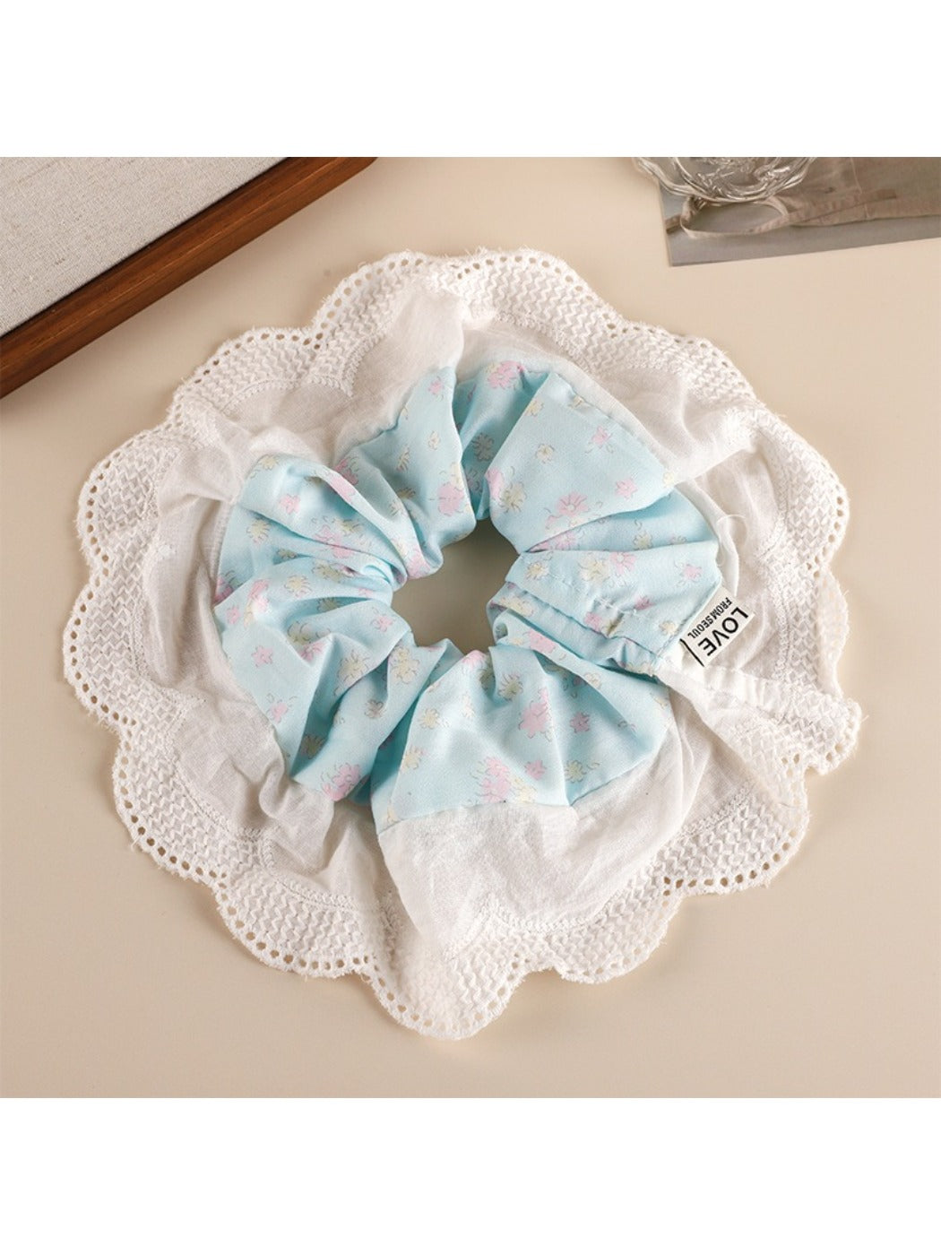 Gifty sweet printed patchwork scrunchie in natural light emphasizing fabric colors