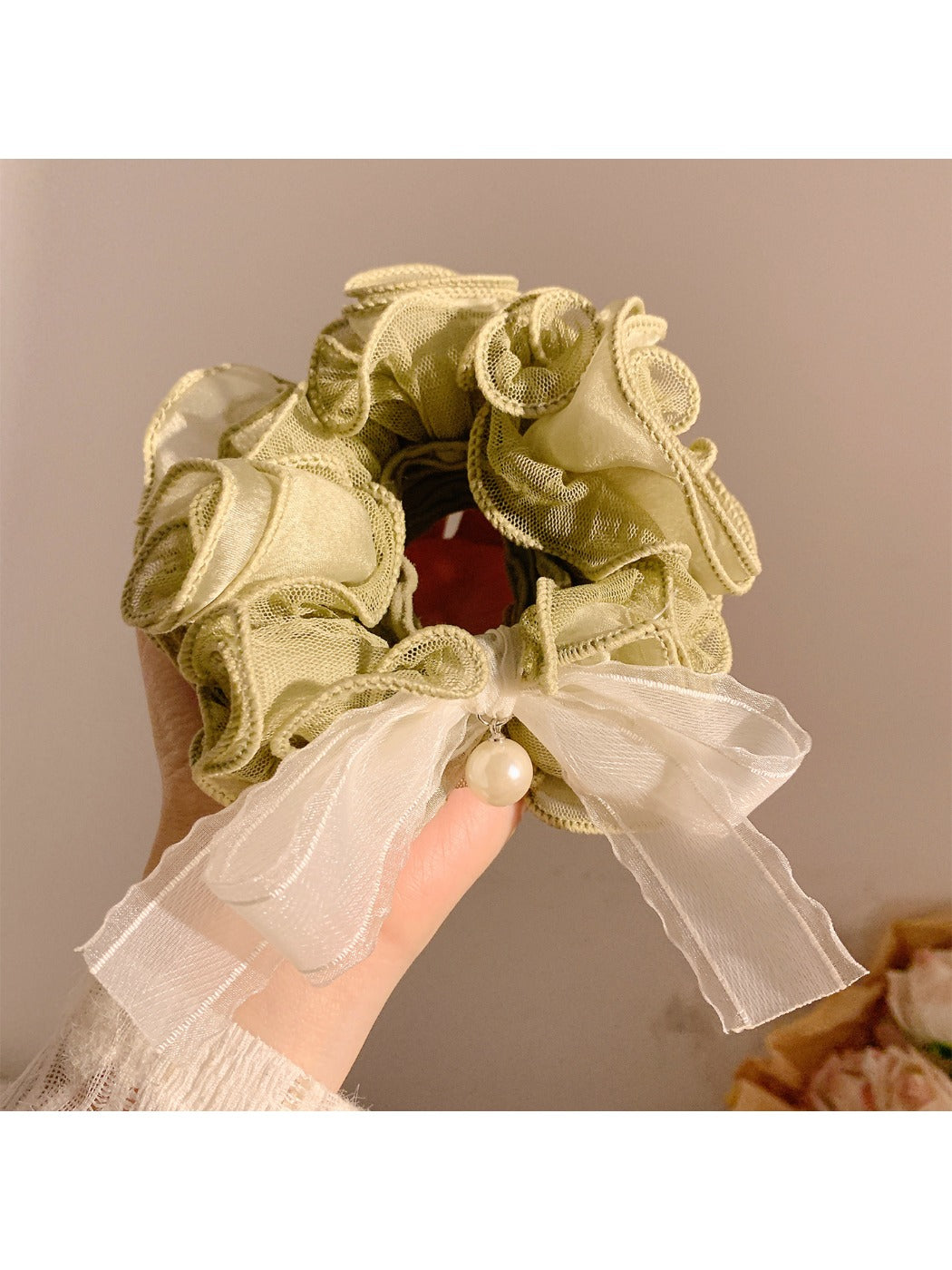 Soft lace bow hair tie styled with casual outfit on a model