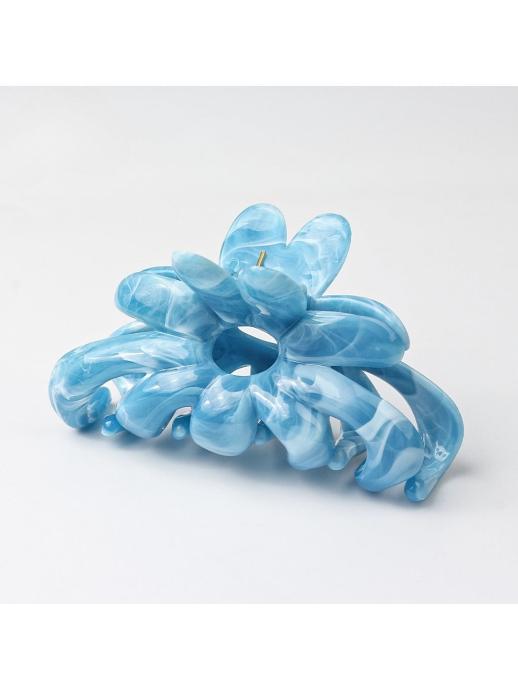 Beau hair clip positioned on a flat surface with natural lighting