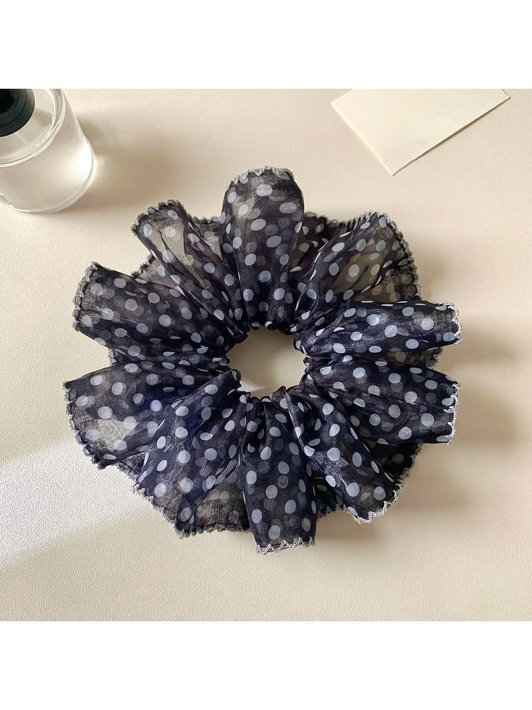 Gifty scrunchie packaging with retro floral design and brand label