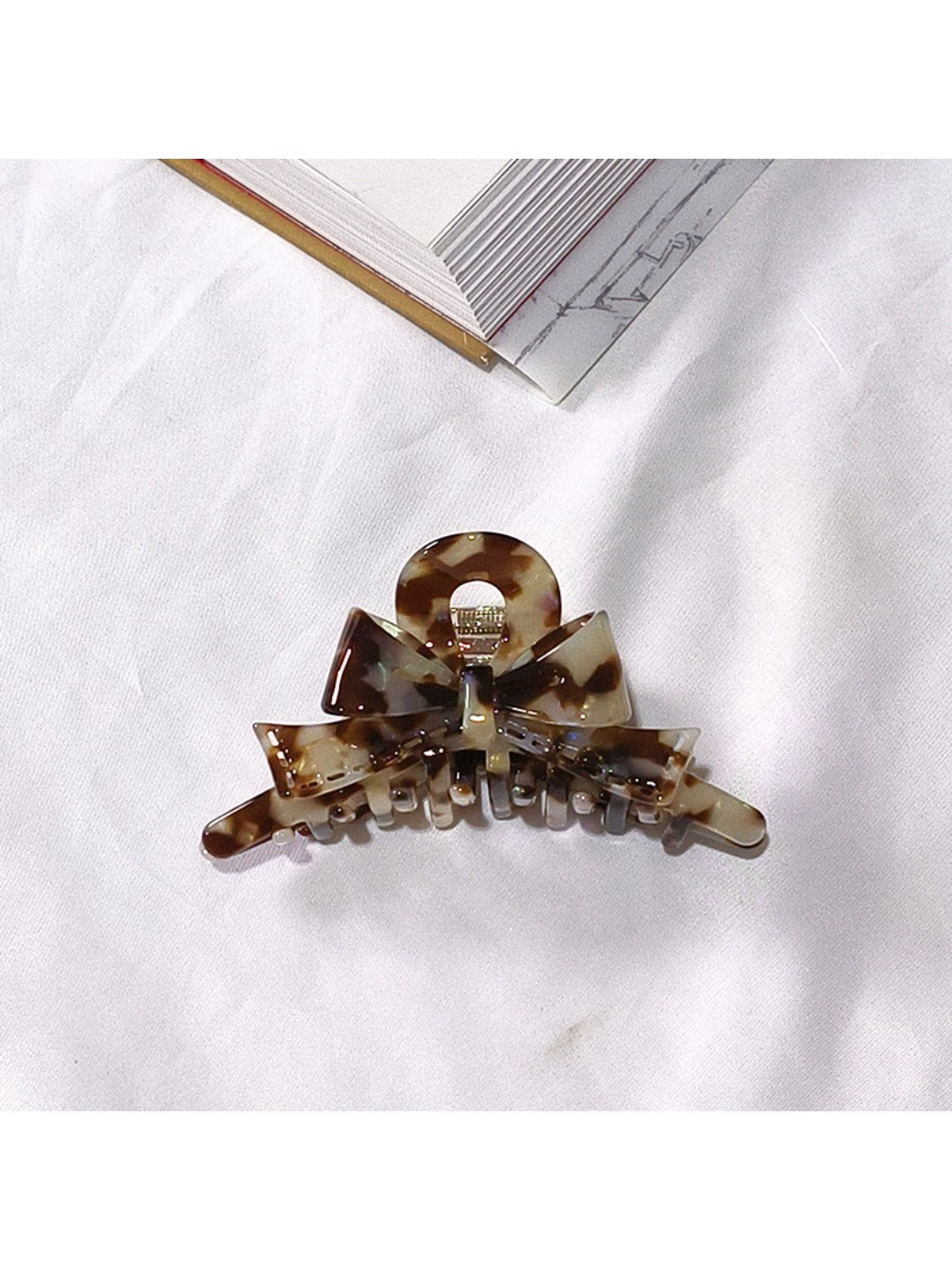 Beau acetate bow shaped claw clip isolated on plain background
