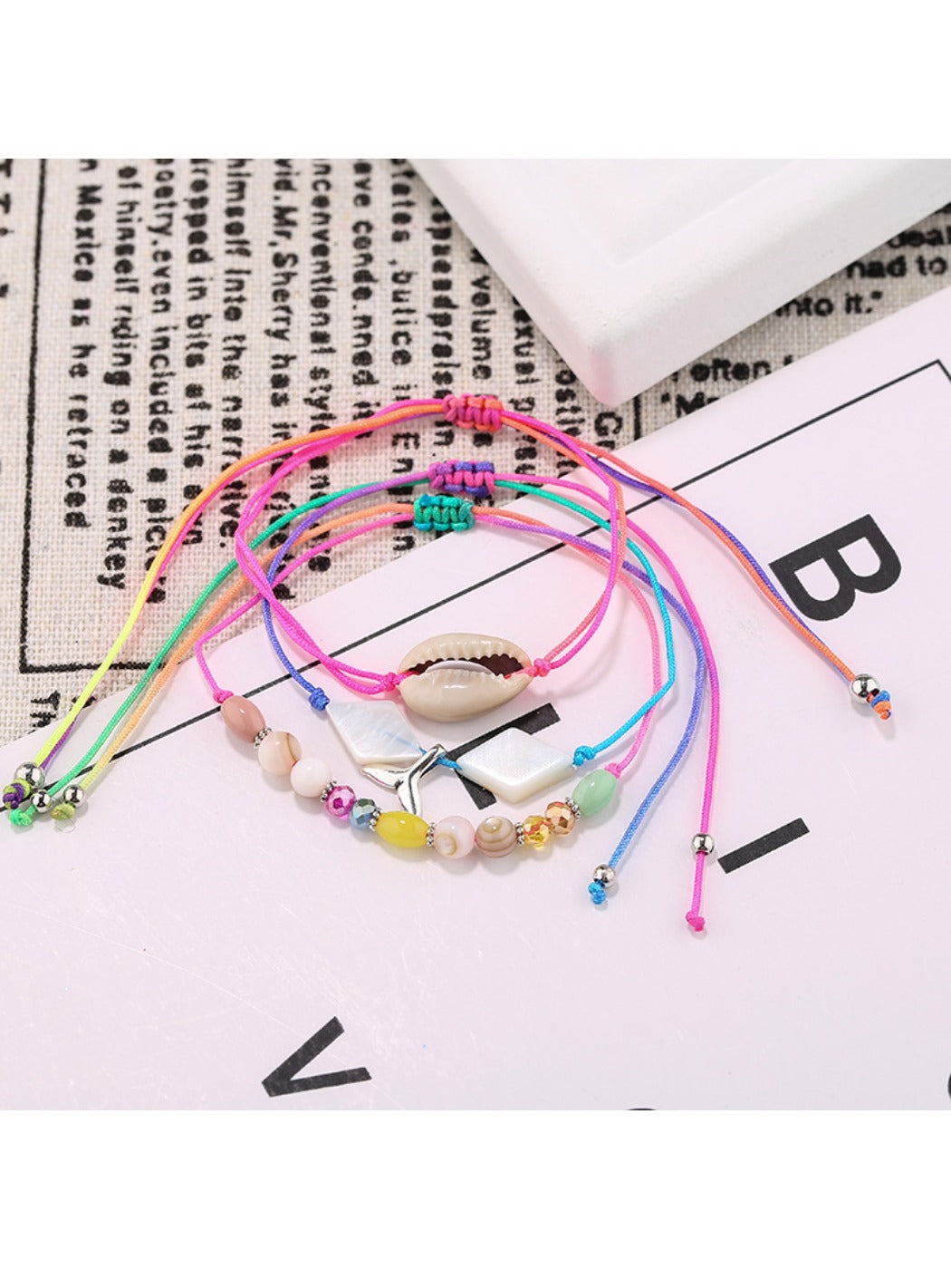 Lovra alloy mermaid tail bracelet coiled to show charm and bead design