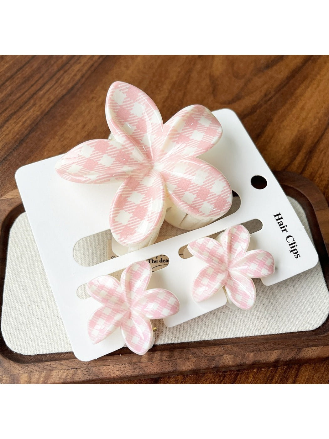 Beau flower claw clips displayed in pastel pink, yellow, green, blue, and purple