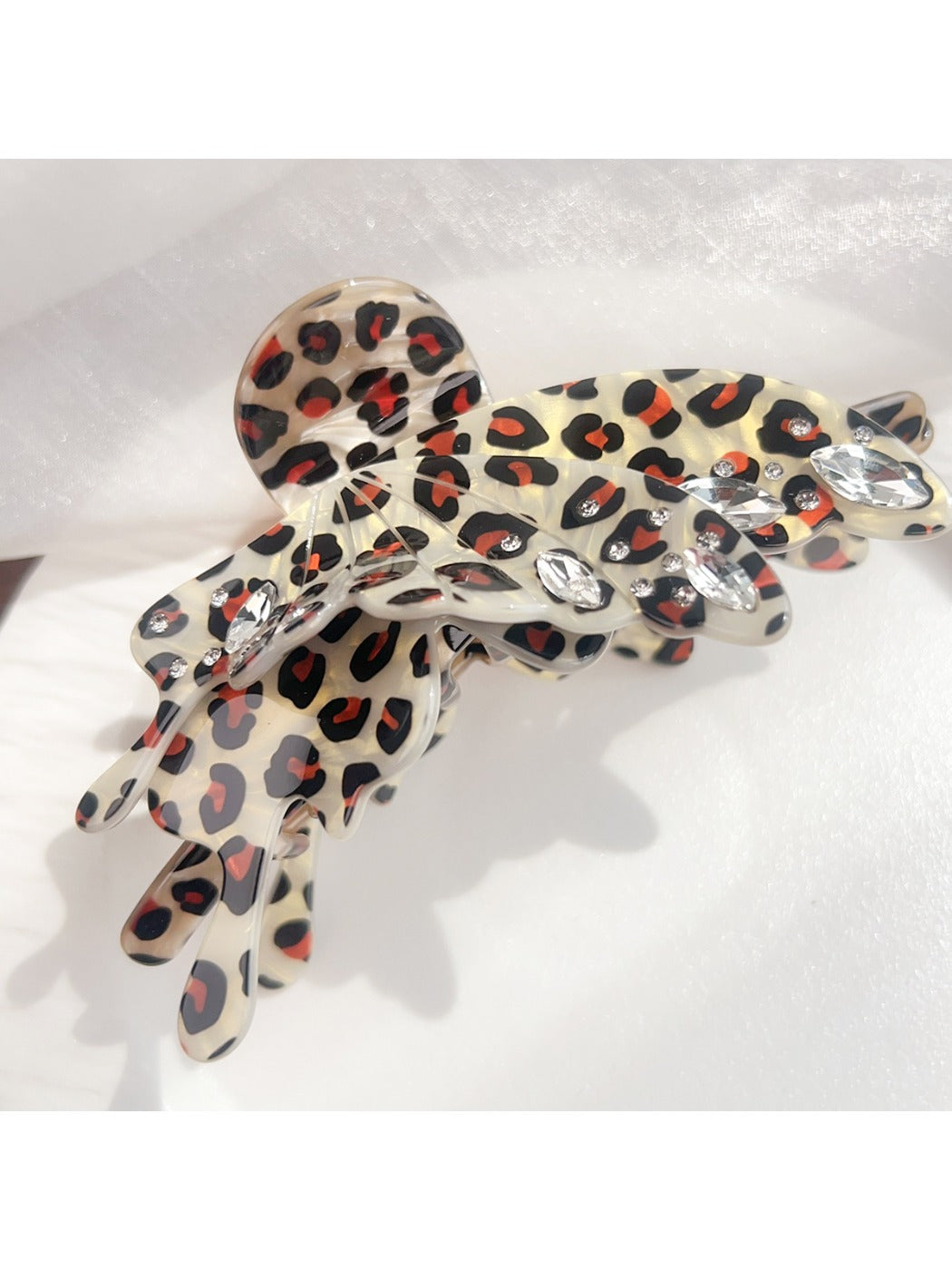 Beau butterfly claw clip with leopard print shown in natural light