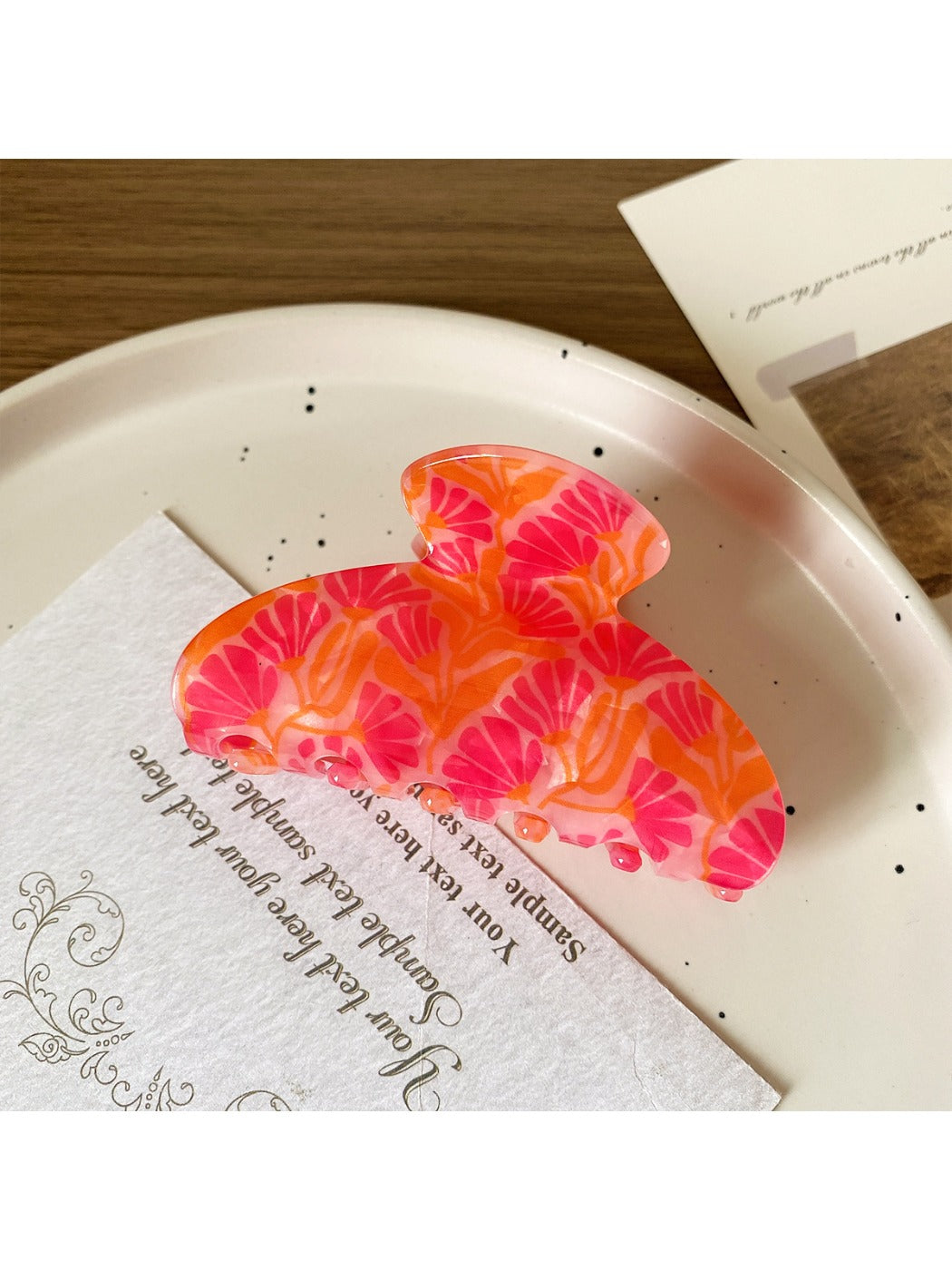 Beau fruit half round hair claw clip on white surface with soft shadows