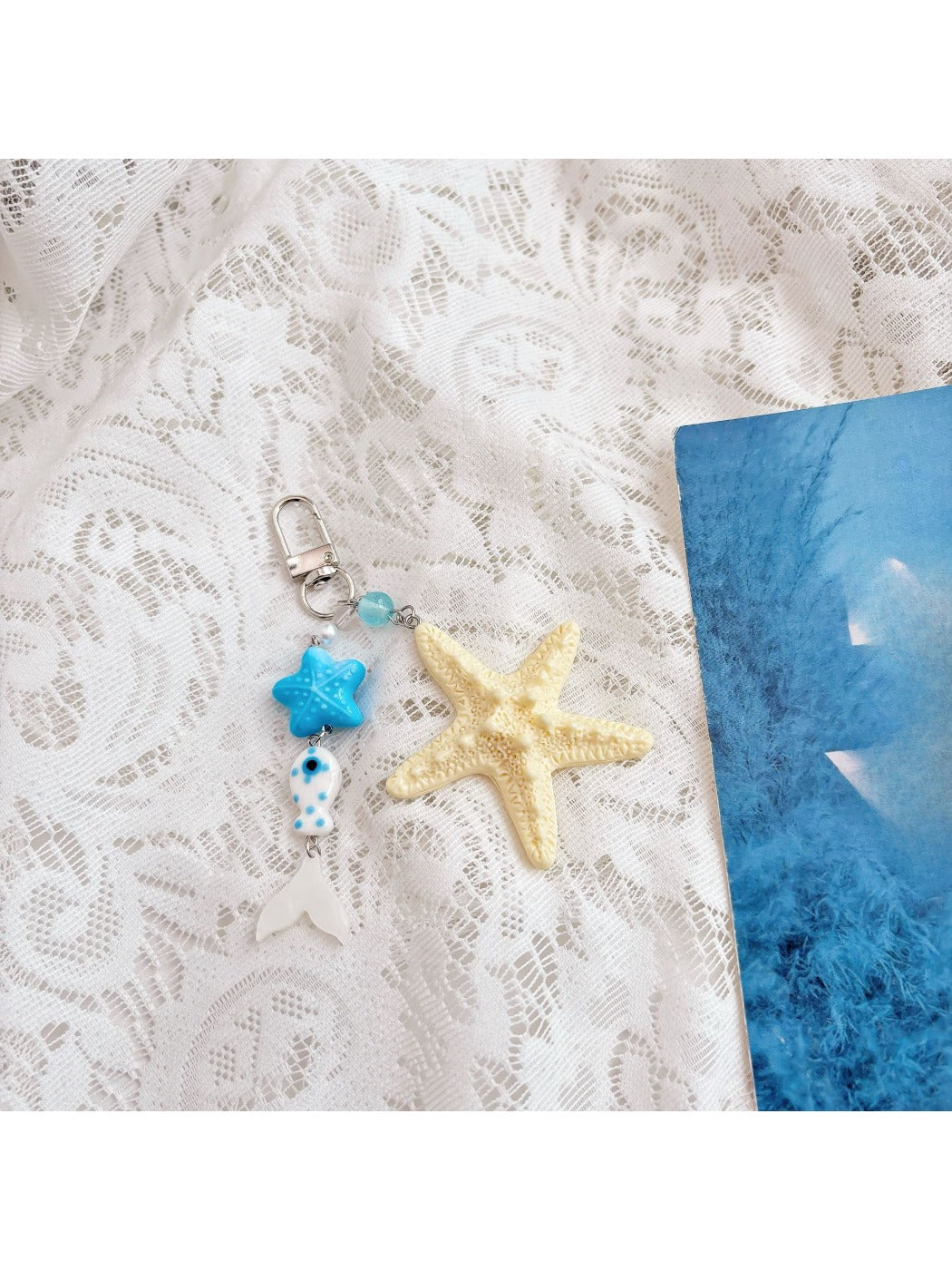 Starfish keychain held in hand to show scale and elegant craftsmanship