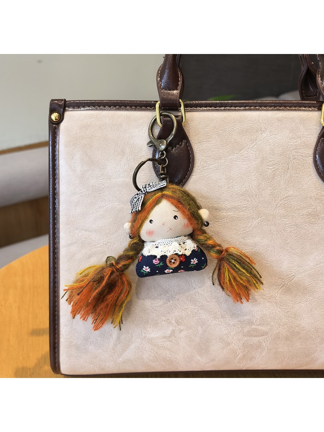 Vintage girl charm keychain shown attached to a backpack zipper pull for decoration