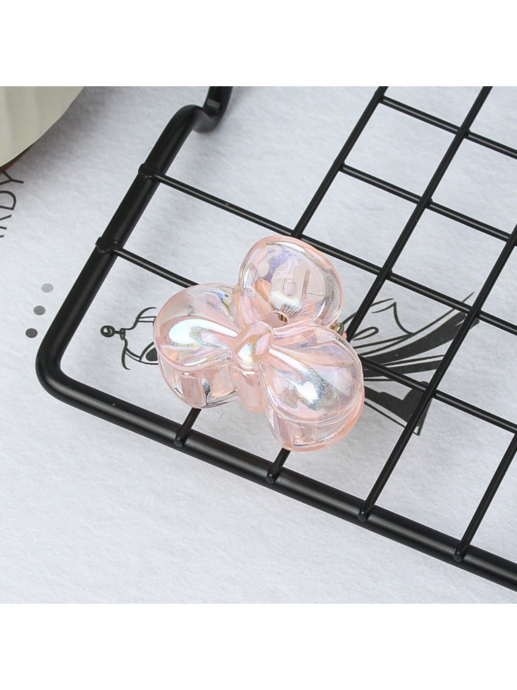 Beau small butterfly claw clip in natural light highlighting soft pink color