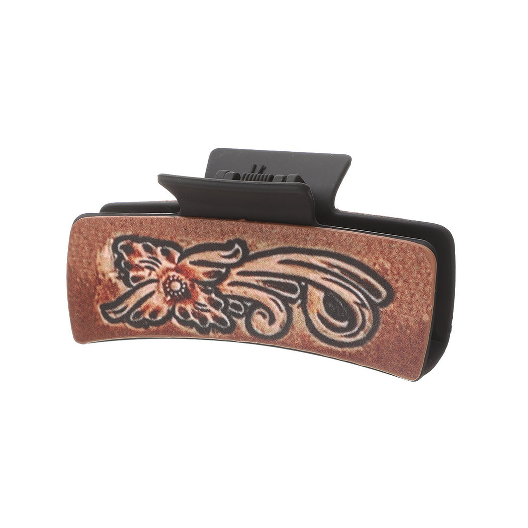 Orange floral hair claw on white background