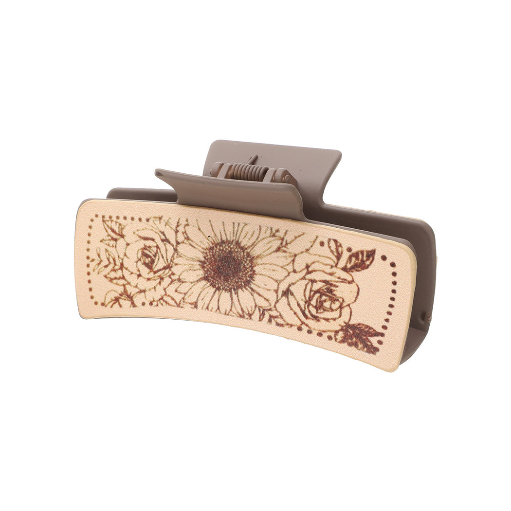 Sunflower and rose hair claw on white background