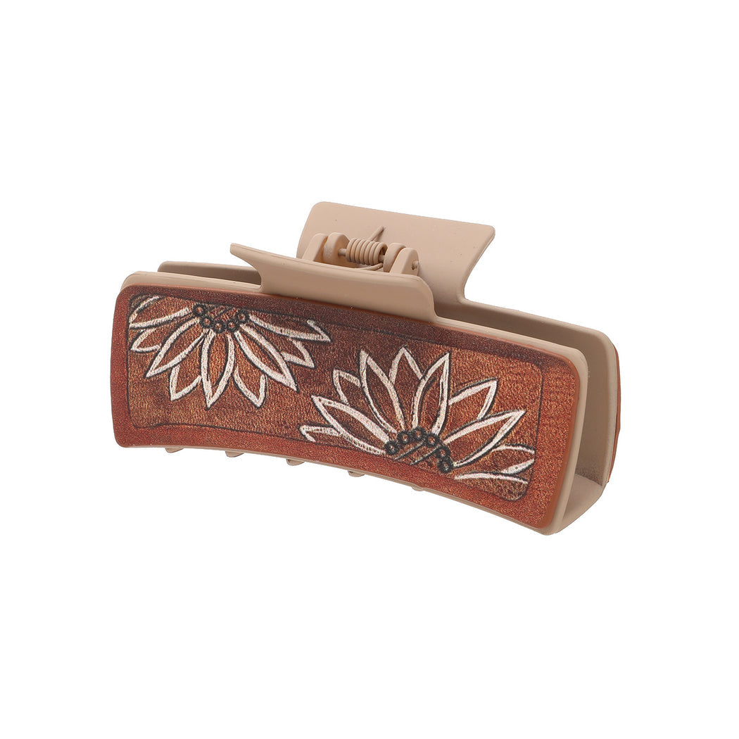Brown sunflower hair claw on white background