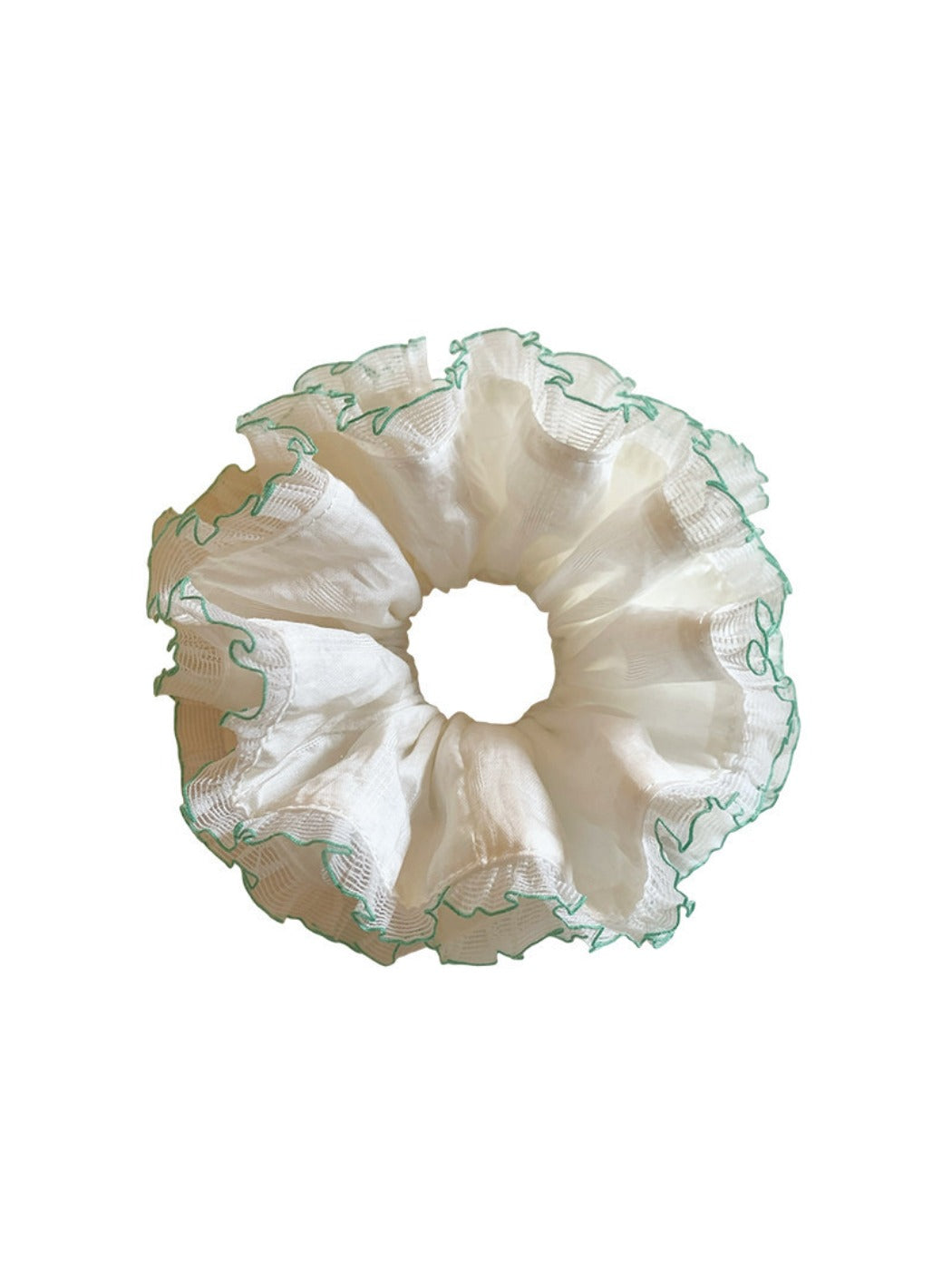 White tulle double scrunchie with green trim displayed on a hand