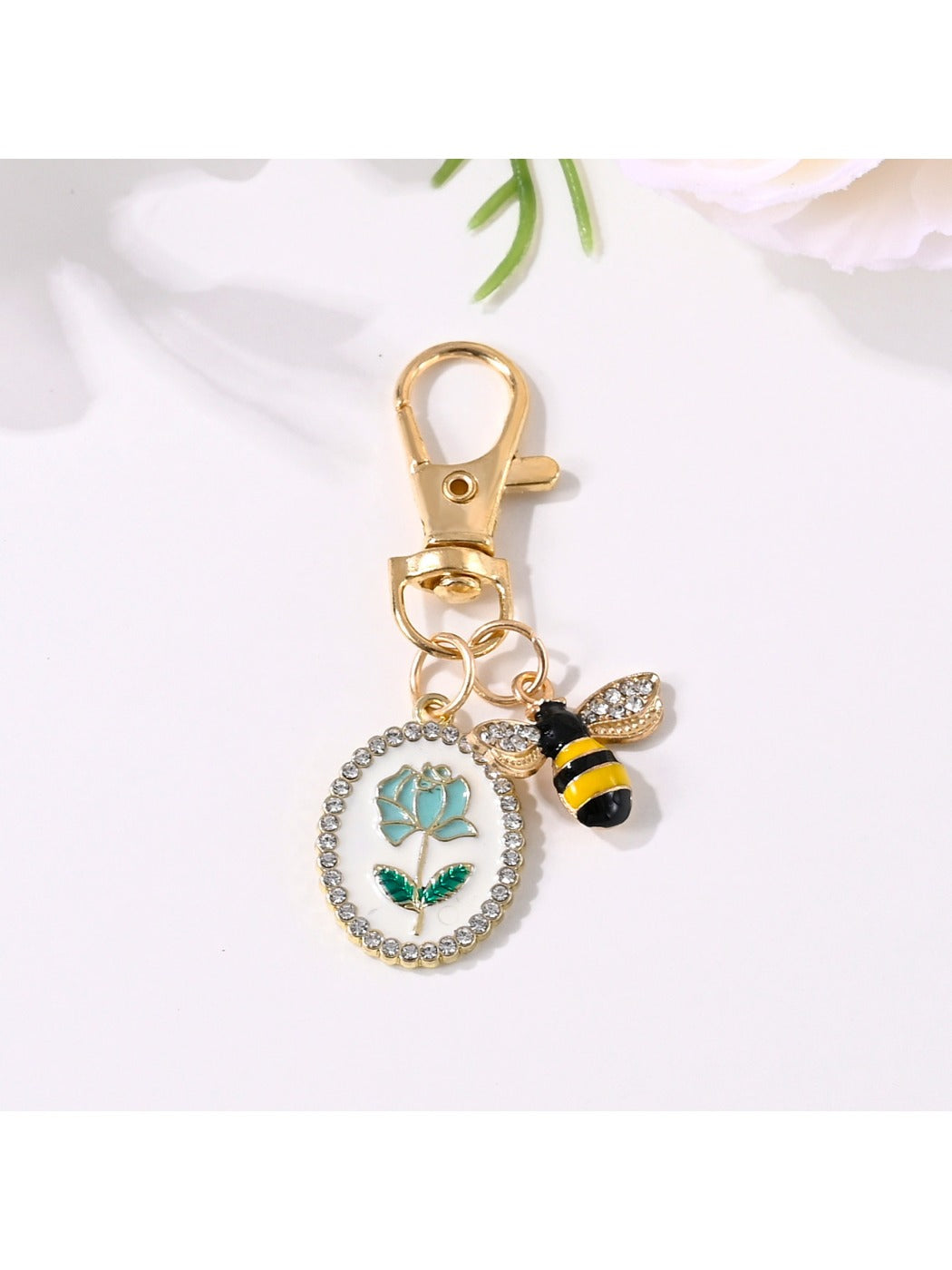 Alloy rose flower print keychain displayed on a white background