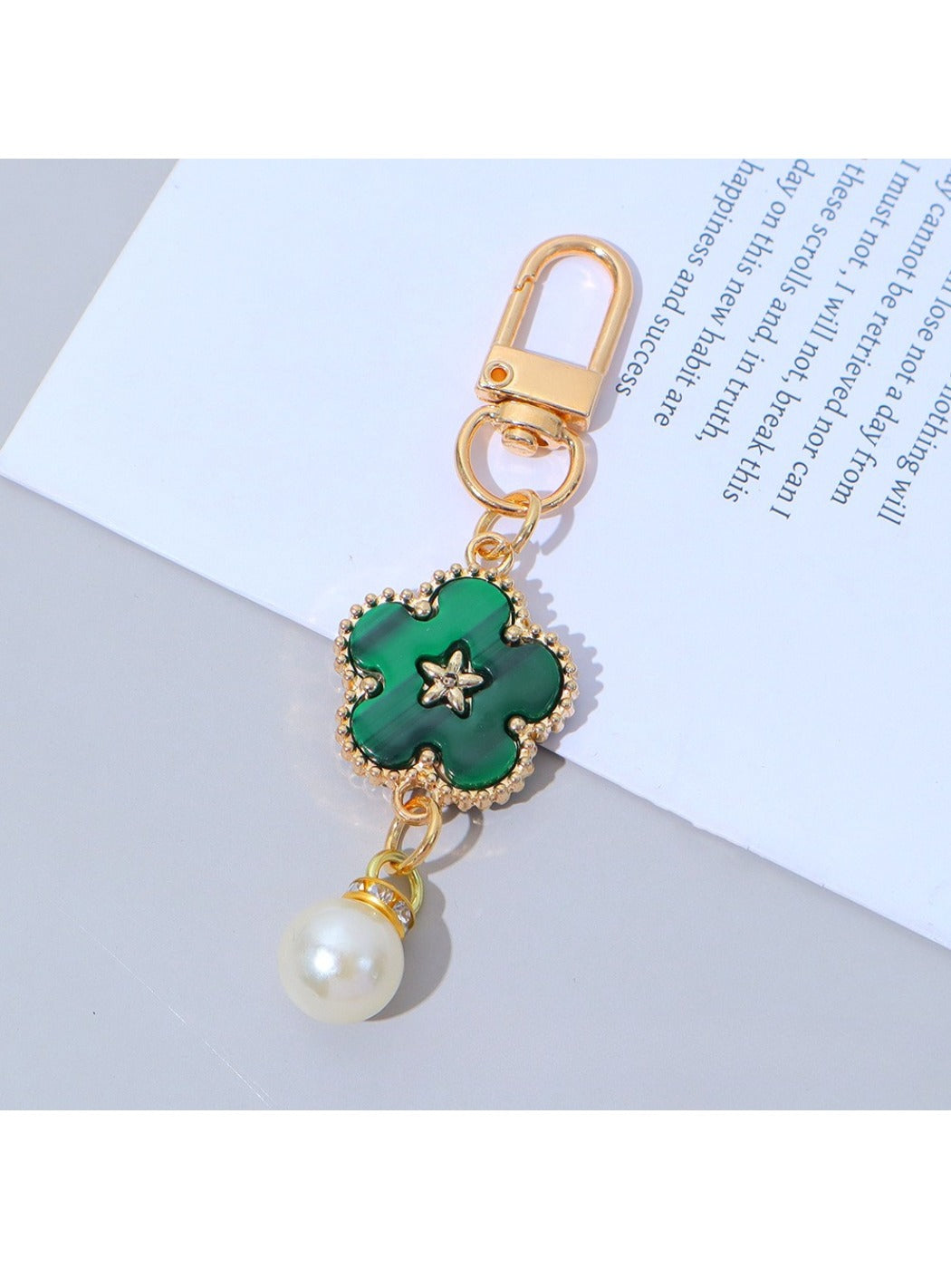 Colorful flower charm keychain hanging from a bag zipper pull