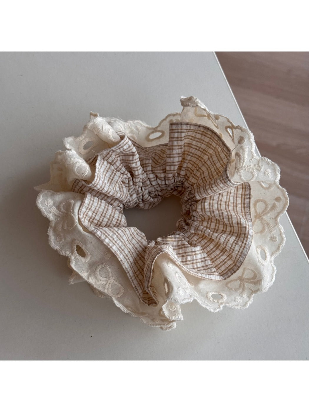Multiple Gifty lace scrunchies in different colors arranged together to show variety