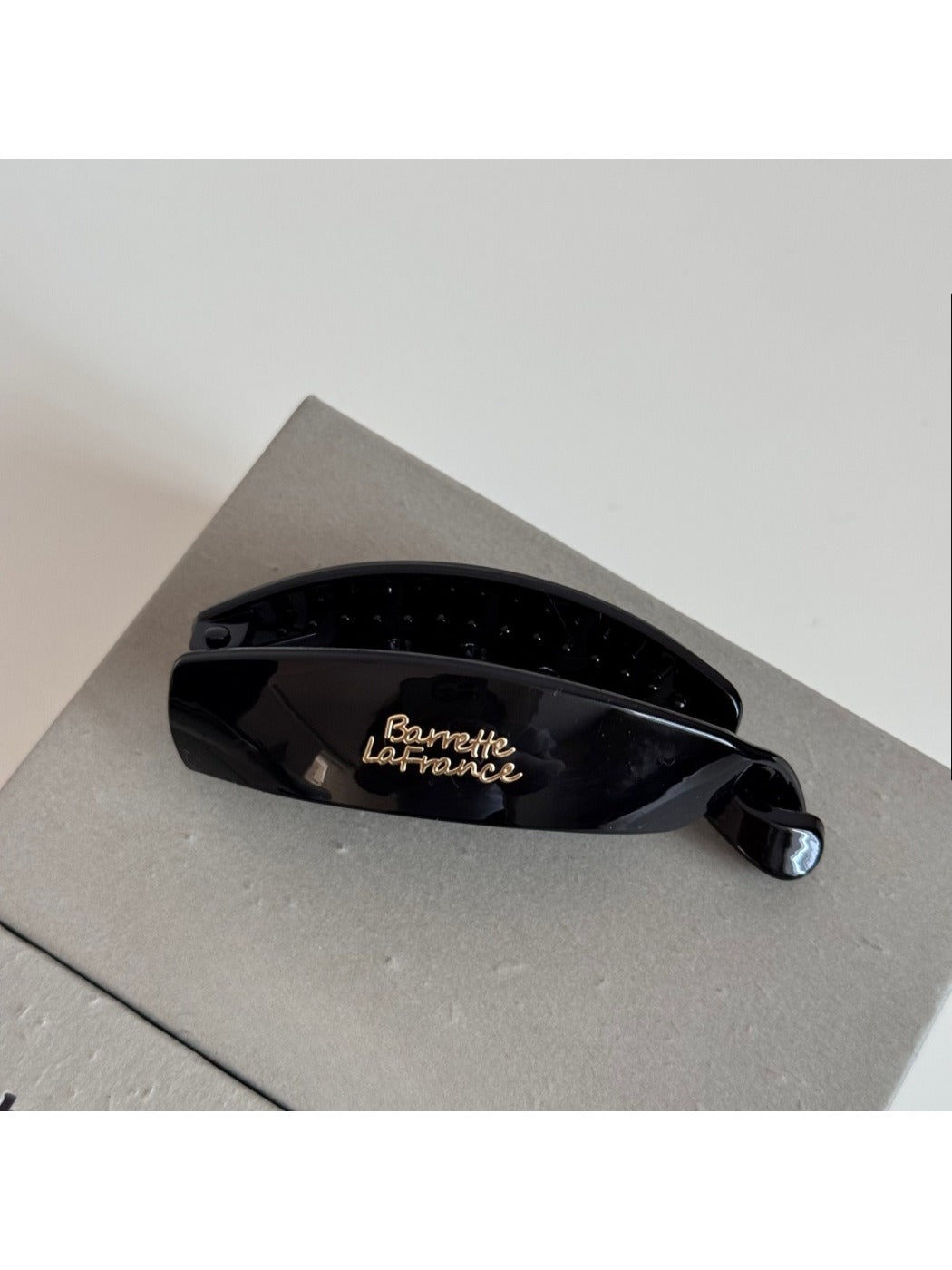 Beau minimalist stick hair clip shown with packaging box on neutral background