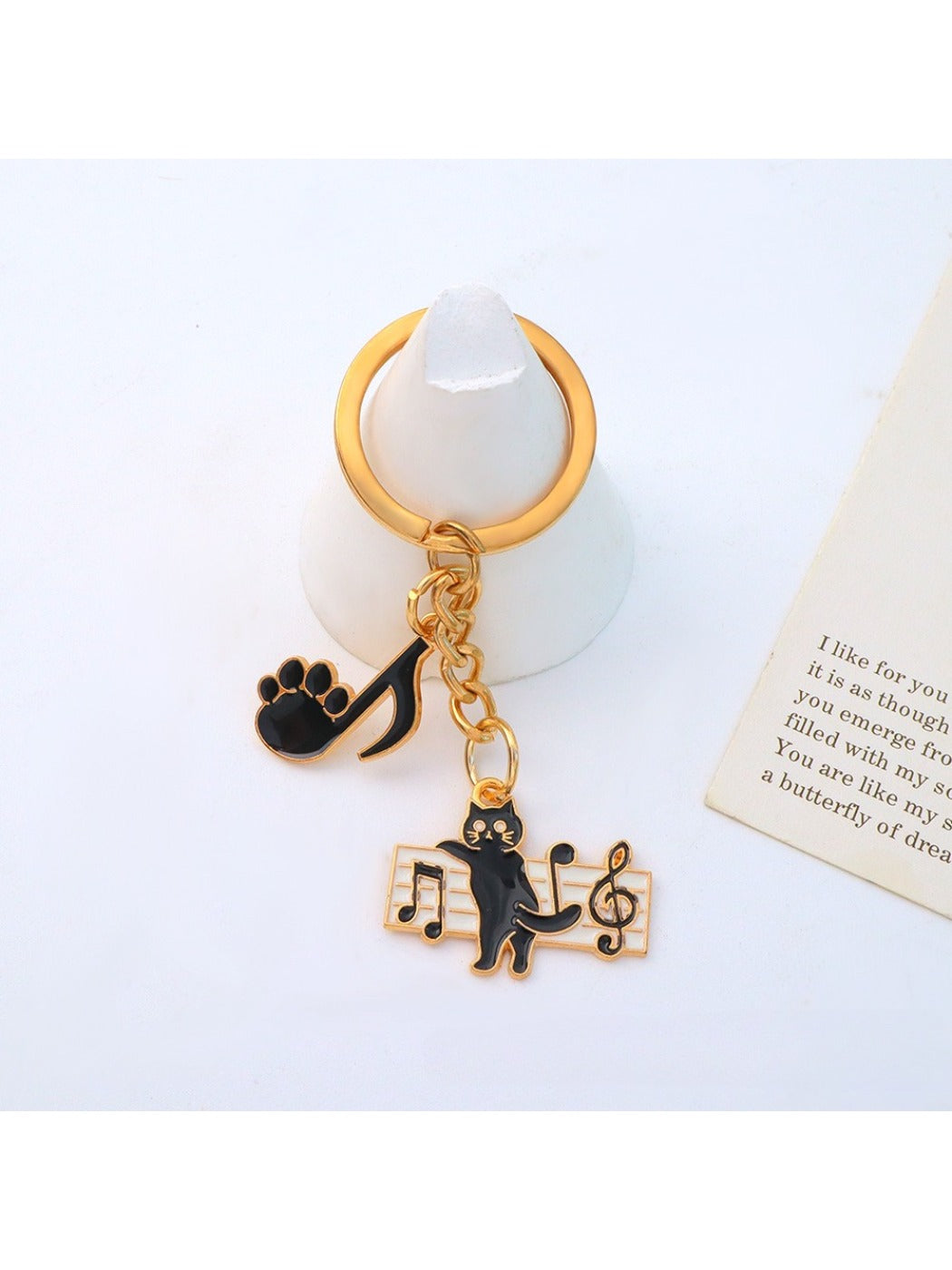 Cartoon cat piano keychain with metal keyring and detailed cat face design