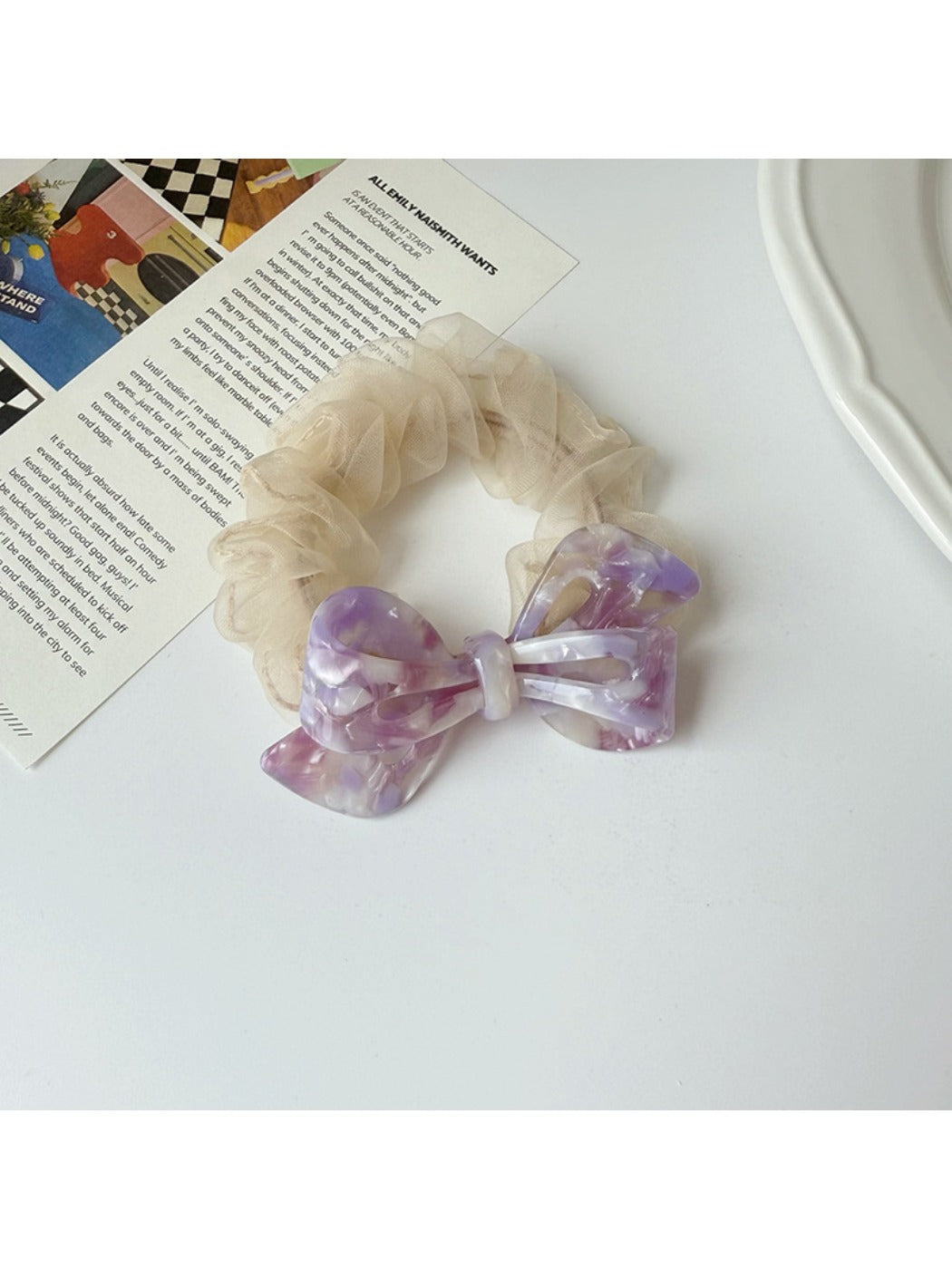 Gifty mesh bow acetate scrunchie laid flat to show full bow shape and material